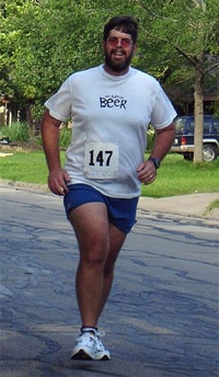 Chubby man running with beer t-shirt. These signs are giving me the feeling